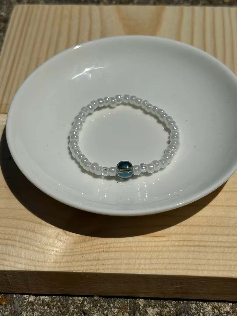 White Beaded Stretch Bracelet with blue Accent Bead